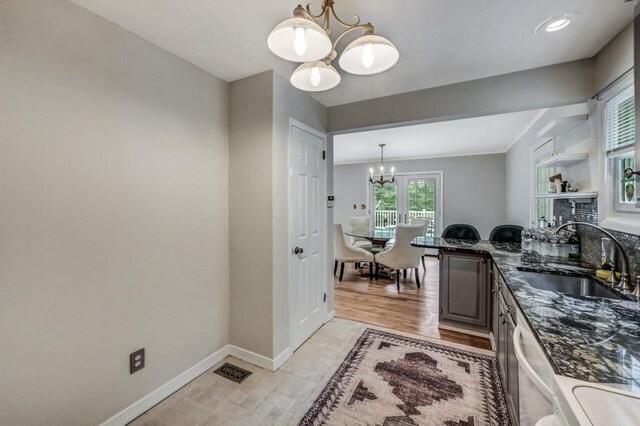 14 Ace Ln, East Stroudsburg, PA 18301 - kitchen featuring a chandelier, a sink, baseboards, stainless steel dishwasher, and decorative light fixtures