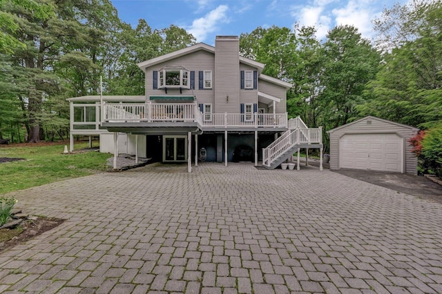 14 Ace Ln, East Stroudsburg, PA 18301 - rear view of house featuring decorative driveway, an outbuilding, a deck, and stairway