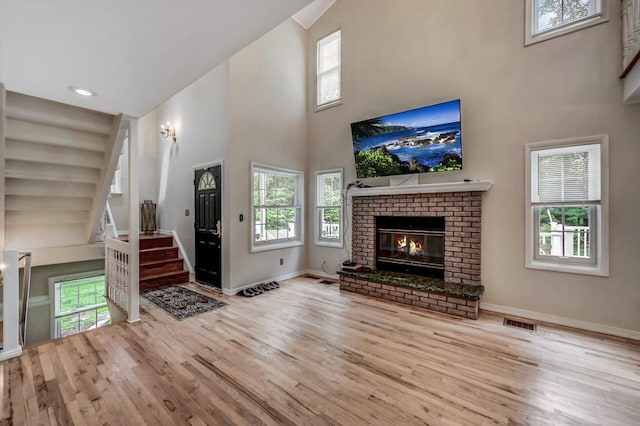 14 Ace Ln, East Stroudsburg, PA 18301 - unfurnished living room with a high ceiling, wood finished floors, baseboards, and plenty of natural light
