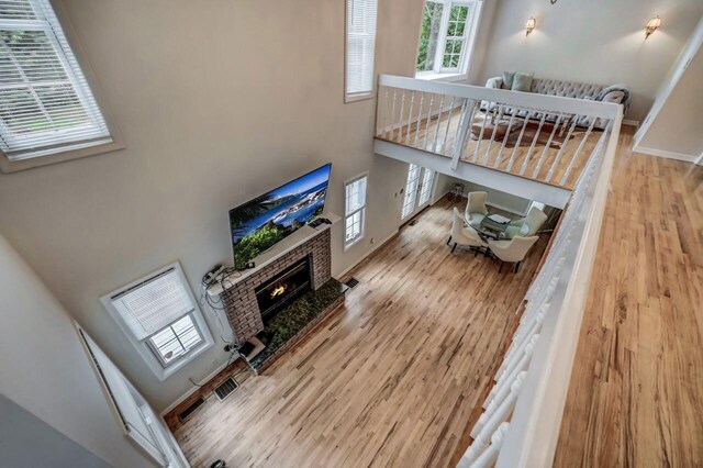 14 Ace Ln, East Stroudsburg, PA 18301 - living room with a high ceiling, wood finished floors, a tiled fireplace, and baseboards