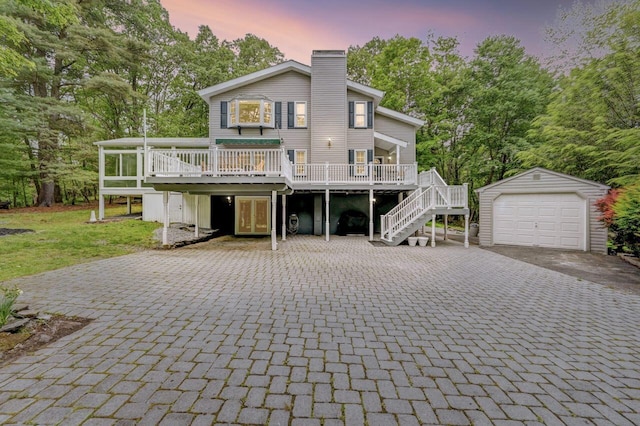 14 Ace Ln, East Stroudsburg, PA 18301 - rear view of property featuring decorative driveway, an outbuilding, a deck, a chimney, and stairs
