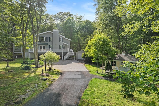 14 Ace Ln, East Stroudsburg, PA 18301 - view of front of property featuring an outdoor structure, stairway, a front yard, and a chimney