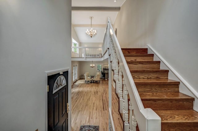 14 Ace Ln, East Stroudsburg, PA 18301 - stairway featuring a chandelier, a towering ceiling, wood finished floors, beam ceiling, and baseboards