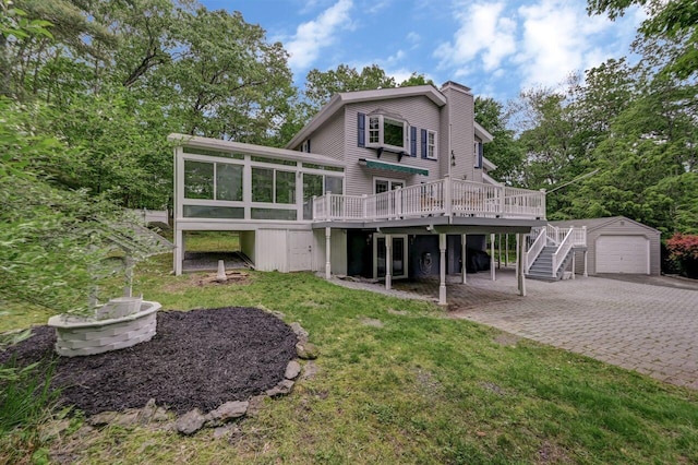 14 Ace Ln, East Stroudsburg, PA 18301 - back of property with decorative driveway, a chimney, an outbuilding, a wooden deck, and a sunroom