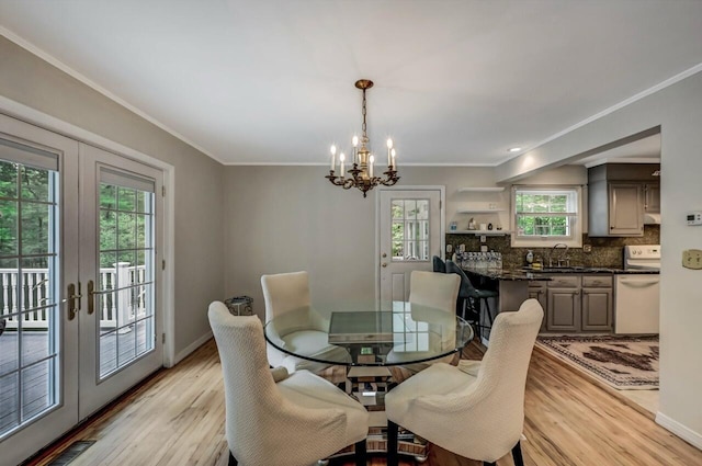 14 Ace Ln, East Stroudsburg, PA 18301 - dining space featuring french doors, a chandelier, light wood-style floors, crown molding, and baseboards