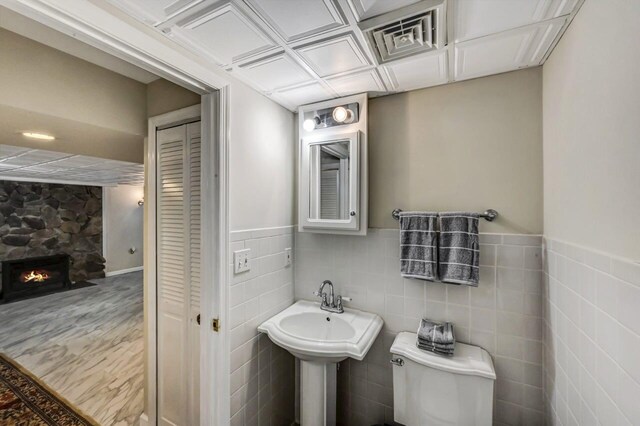 14 Ace Ln, East Stroudsburg, PA 18301 - bathroom with toilet, a closet, a fireplace, and wainscoting