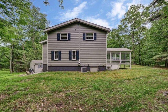 14 Ace Ln, East Stroudsburg, PA 18301 - back of house with a sunroom, a lawn, and central AC unit