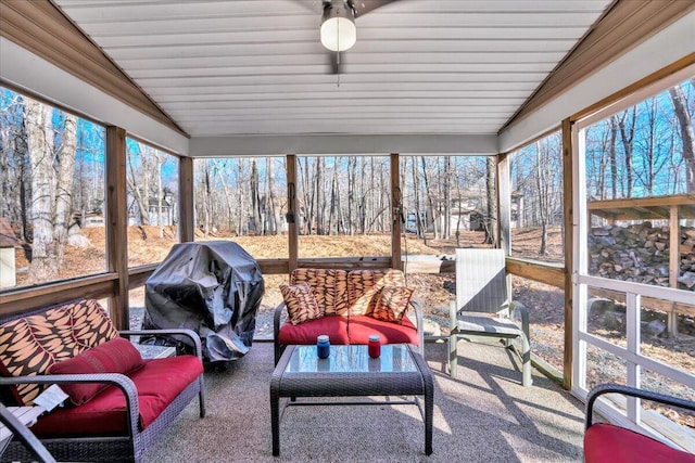 sunroom / solarium featuring vaulted ceiling