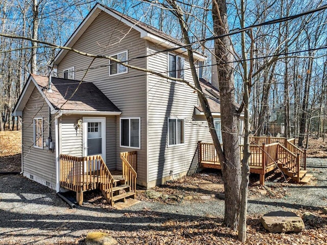 back of house featuring a deck, a shingled roof, and crawl space