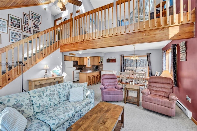 living area featuring baseboards, light colored carpet, stairs, baseboard heating, and ceiling fan with notable chandelier