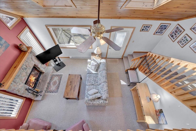 living room with a baseboard radiator, wood ceiling, stairs, and lofted ceiling