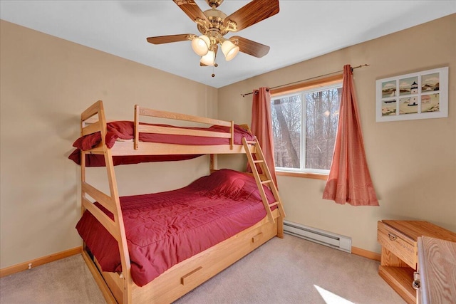 bedroom featuring a baseboard heating unit, carpet flooring, a ceiling fan, and baseboards