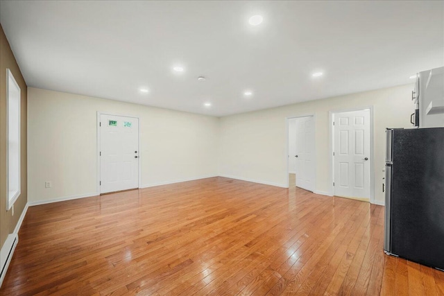 428 Shook Ave, Stroudsburg, PA 18360 - unfurnished living room featuring light wood finished floors, recessed lighting, and a baseboard heating unit