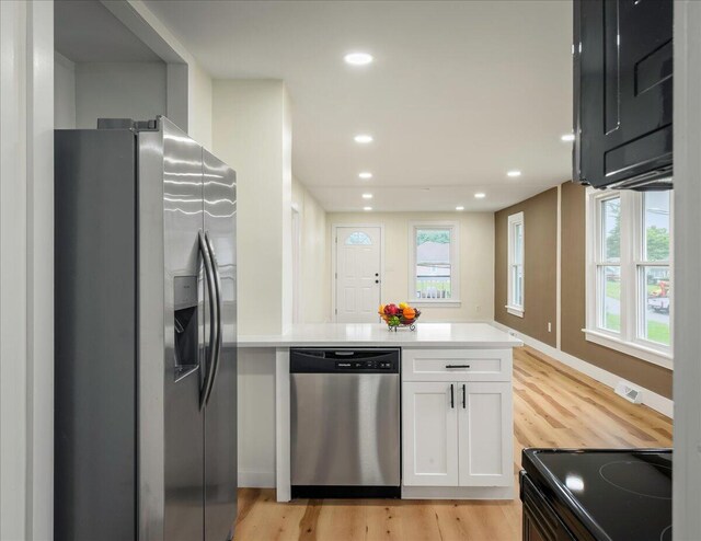 428 Shook Ave, Stroudsburg, PA 18360 - kitchen featuring stainless steel appliances, a peninsula, white cabinets, light wood finished floors, and light countertops