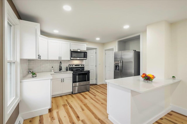 428 Shook Ave, Stroudsburg, PA 18360 - kitchen featuring stainless steel appliances, decorative backsplash, light wood-type flooring, white cabinets, and recessed lighting