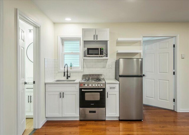 428 Shook Ave, Stroudsburg, PA 18360 - kitchen with stainless steel appliances, light countertops, decorative backsplash, dark wood finished floors, and white cabinetry
