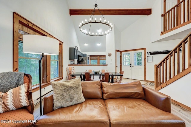 living area featuring french doors, a notable chandelier, wood finished floors, beamed ceiling, and stairs