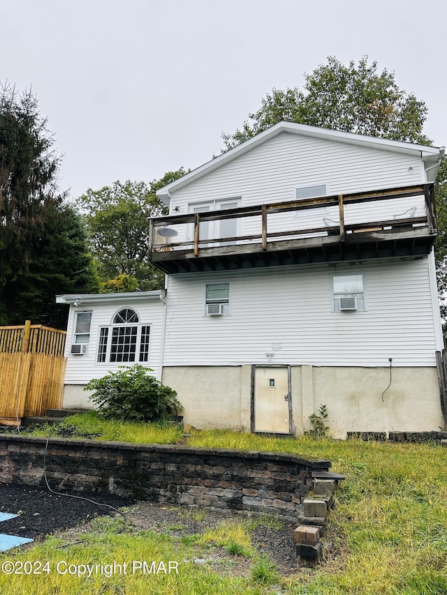 rear view of property featuring cooling unit and fence