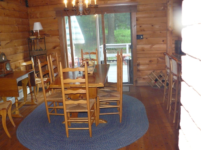 1006 Mill Creek Rd, Newfoundland, PA 18445 - dining area with hardwood / wood-style flooring, a chandelier, and log walls