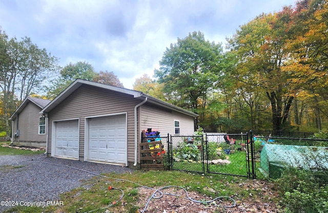 garage with a gate and fence