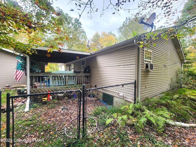 view of property exterior featuring fence and a wooden deck