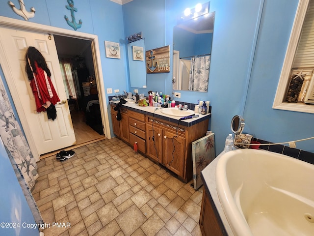 bathroom featuring a tub to relax in, double vanity, and a sink