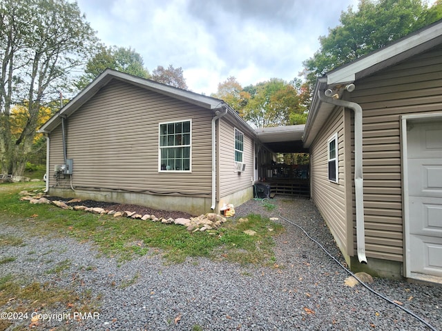 view of property exterior with gravel driveway and a garage