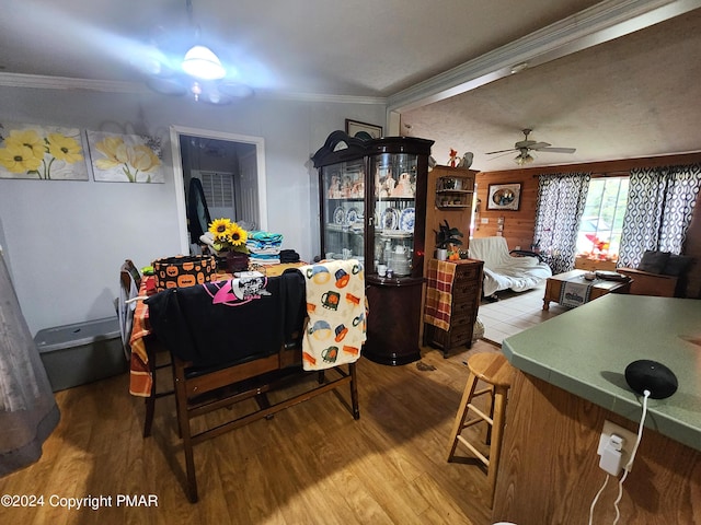 dining room with crown molding, ceiling fan, and wood finished floors