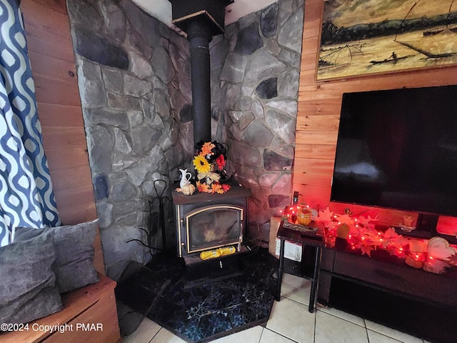 interior details with a wood stove and wooden walls