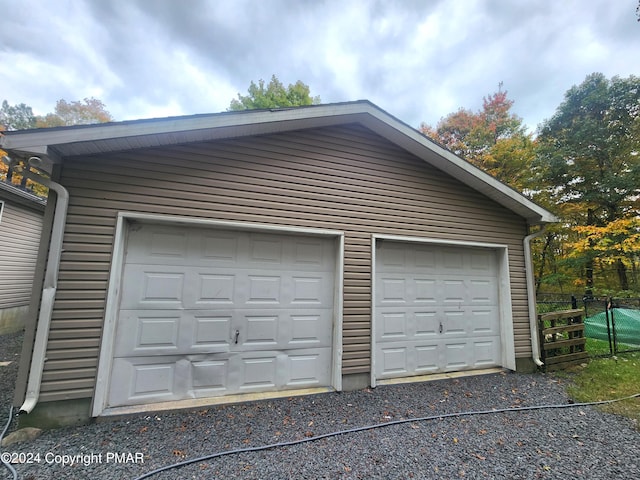 detached garage featuring fence