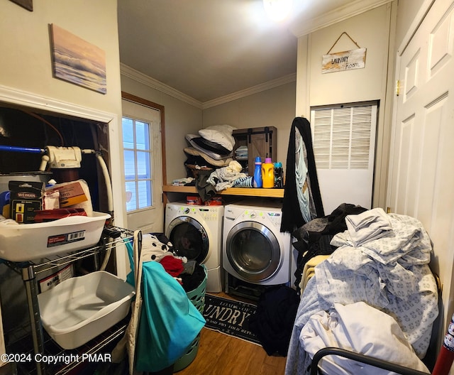 washroom featuring laundry area, ornamental molding, independent washer and dryer, and wood finished floors