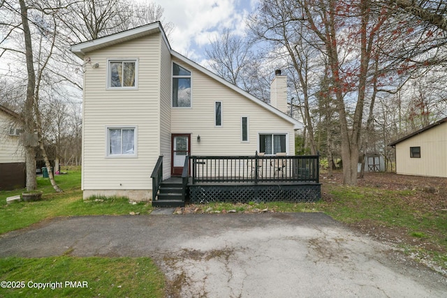 back of house featuring a wooden deck