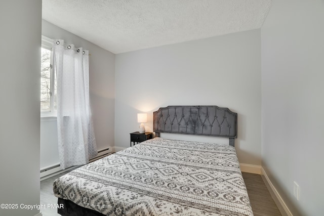 bedroom featuring a baseboard radiator, a textured ceiling, and dark hardwood / wood-style flooring