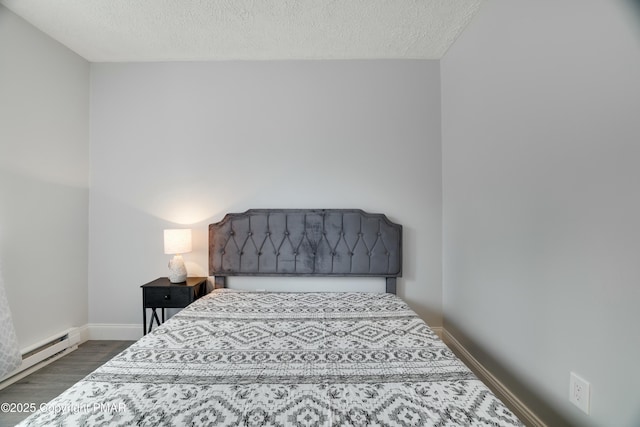 bedroom featuring a textured ceiling, dark wood-type flooring, and a baseboard radiator