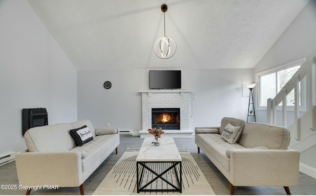 living room featuring lofted ceiling, a brick fireplace, dark hardwood / wood-style flooring, and baseboard heating