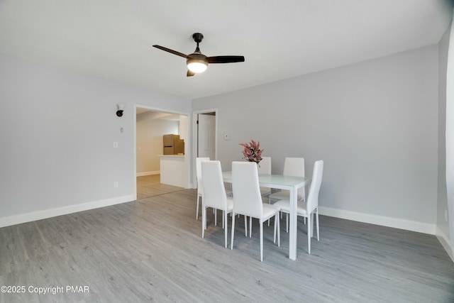 dining space featuring ceiling fan and wood-type flooring