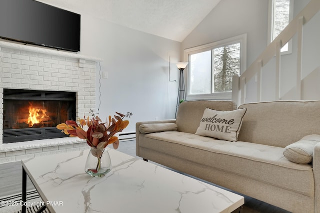 living room featuring vaulted ceiling and a brick fireplace