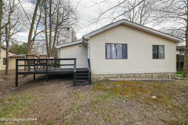 rear view of property with a wooden deck