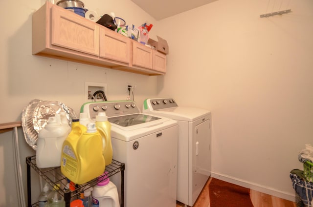 clothes washing area with cabinet space, baseboards, and separate washer and dryer