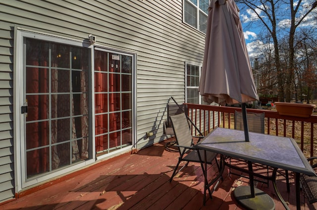 wooden terrace featuring outdoor dining area