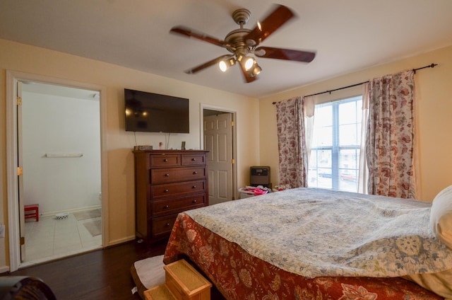 bedroom with a ceiling fan, baseboards, and dark wood-style flooring