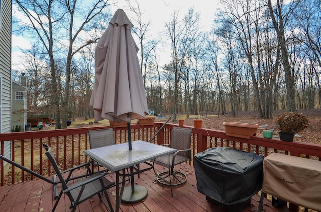 wooden deck with area for grilling and outdoor dining area