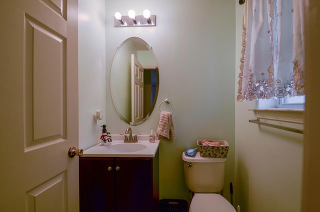 half bathroom with toilet and vanity