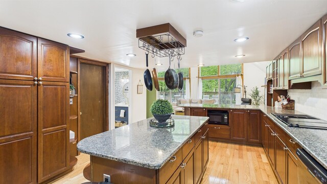 112 Moshannon Dr, Pocono Lake, PA 18347 - kitchen with black appliances, light wood-style flooring, light stone countertops, a peninsula, and recessed lighting