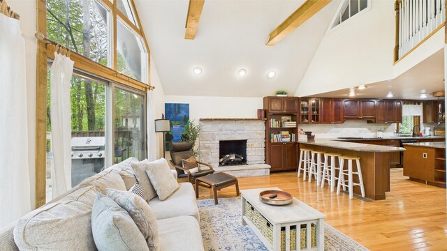 112 Moshannon Dr, Pocono Lake, PA 18347 - living room featuring high vaulted ceiling, light wood-style flooring, beamed ceiling, a stone fireplace, and recessed lighting