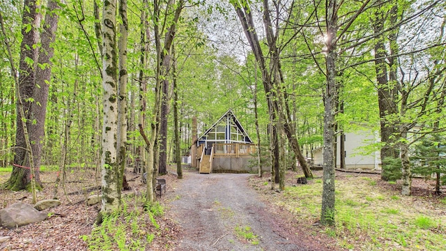 112 Moshannon Dr, Pocono Lake, PA 18347 - view of dirt / gravel driveway featuring stairs and a wooded view