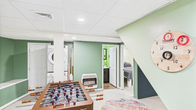 112 Moshannon Dr, Pocono Lake, PA 18347 - game room with stacked washer / dryer, a drop ceiling, heating unit, and recessed lighting
