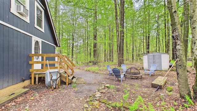112 Moshannon Dr, Pocono Lake, PA 18347 - view of yard featuring an outdoor fire pit, a wooden deck, and cooling unit