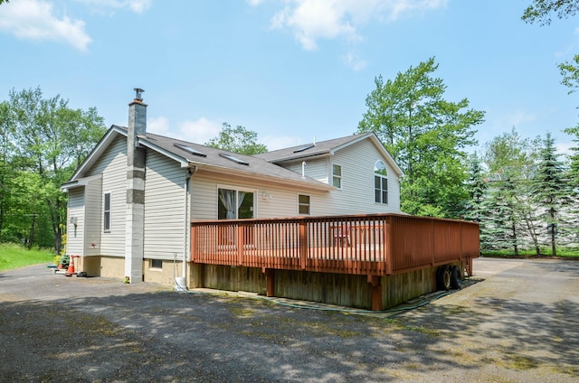 1214 Shadblow Rd, Pocono Summit, PA 18346 - rear view of property with a chimney and a wooden deck