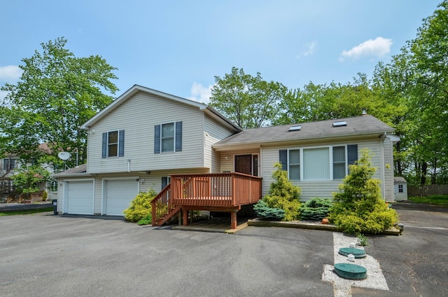 1214 Shadblow Rd, Pocono Summit, PA 18346 - tri-level home with a wooden deck, an attached garage, and stairway